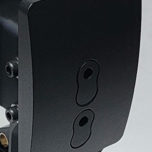 May include: Black metal plate with two oval-shaped cutouts and the text "SIM LAB" printed on the bottom right corner.