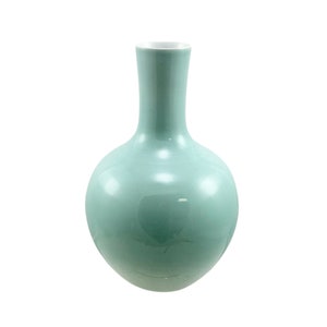May include: A light blue ceramic vase with a round body and a narrow neck.