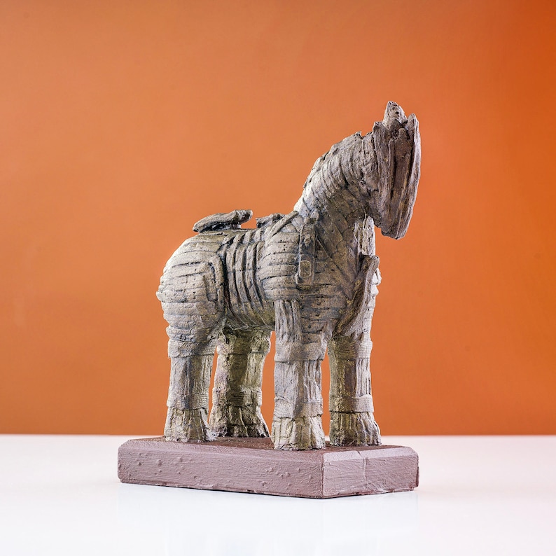 Marble dust Trojan Horse statue with a striated acrylic finish in charcoal and umber shades, on a terracotta backdrop for contrast