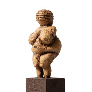 Studio photograph of the Prehistoric Venus of Willendorf Figurine on a clean white background, revealing the detailed curves and natural stone texture. Symbol of fertility, beauty, and the power of womanhood in ancient civilizations. Handmade museum-quality replica for goddess art lovers by ArkeoArt.