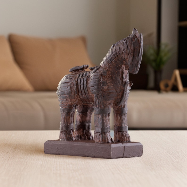 Marble dust Trojan Horse statue with a striated acrylic finish in charcoal and umber shades, on a terracotta backdrop for contrast