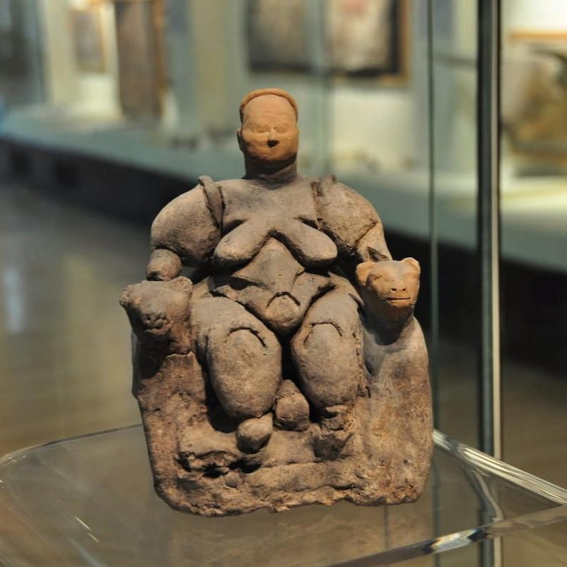 Neolithic Çatalhöyük Cybele figurine replica, symbolizing fertility with its voluptuous curves and prominent bust detail, from the Museum of Anatolian Civilizations.
