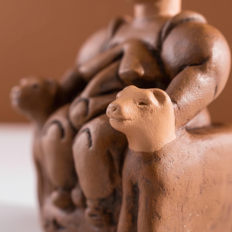 Macro shot of the Çatalhöyük Mother Goddess showing subtle sculptural details and handcrafted surface patterns. The close-up captures the symbolic posture and fertility theme of prehistoric Anatolia. A celebration of Neolithic artistry and sacred motherhood.