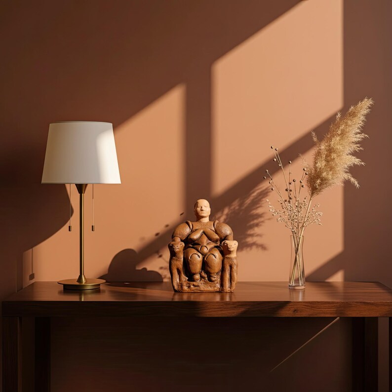 The Neolithic Mother Goddess statue placed near books and candles in a sunlit boho interior. The warm terracotta tones and spiritual presence of the piece bring ancient Anatolian serenity into modern living spaces. A timeless expression of the divine feminine by ArkeoArt.