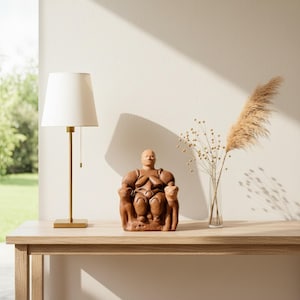 Top view of the Cybele Mother Goddess statue surrounded by archaeological tools, papyrus, and earthen textures. The composition celebrates humanity’s earliest art of worship and creation, connecting the viewer to the sacred Neolithic past through ArkeoArt’s craftsmanship.