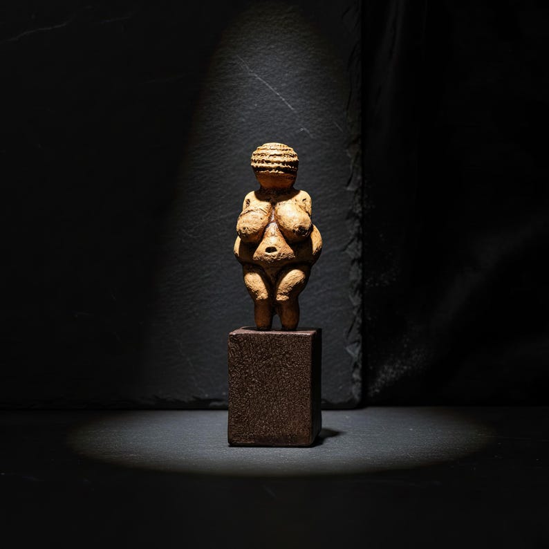 Artistic composition of the Venus of Willendorf Sculpture styled with soft shadows and warm lighting. Represents prehistoric goddess worship, female energy, and the continuity of creation. A captivating handmade replica for collectors and spiritual art admirers by ArkeoArt.