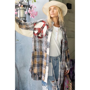 May include: A long-sleeved, oversized plaid shirt with a peace sign patch on the left side. The shirt is made of a soft, comfortable fabric and has a relaxed fit. The shirt is a patchwork of different fabrics and colours, including blue, brown, and white.
