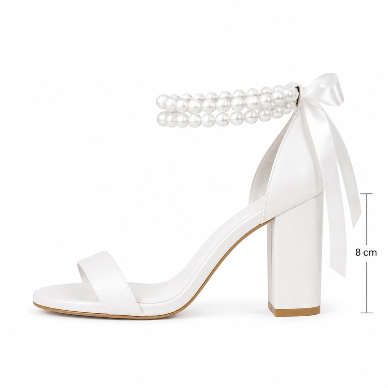 White bridal sandals with double pearl ankle straps displayed inside a YvollaShoes wedding shoe box with luxury bridal details.