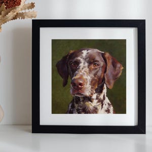 May include: A square black frame containing a portrait painting of a brown and white spotted dog with a dark green background. Next to the frame is a white ceramic vase with a wavy, organic shape holding several dried brown banksia flowers.