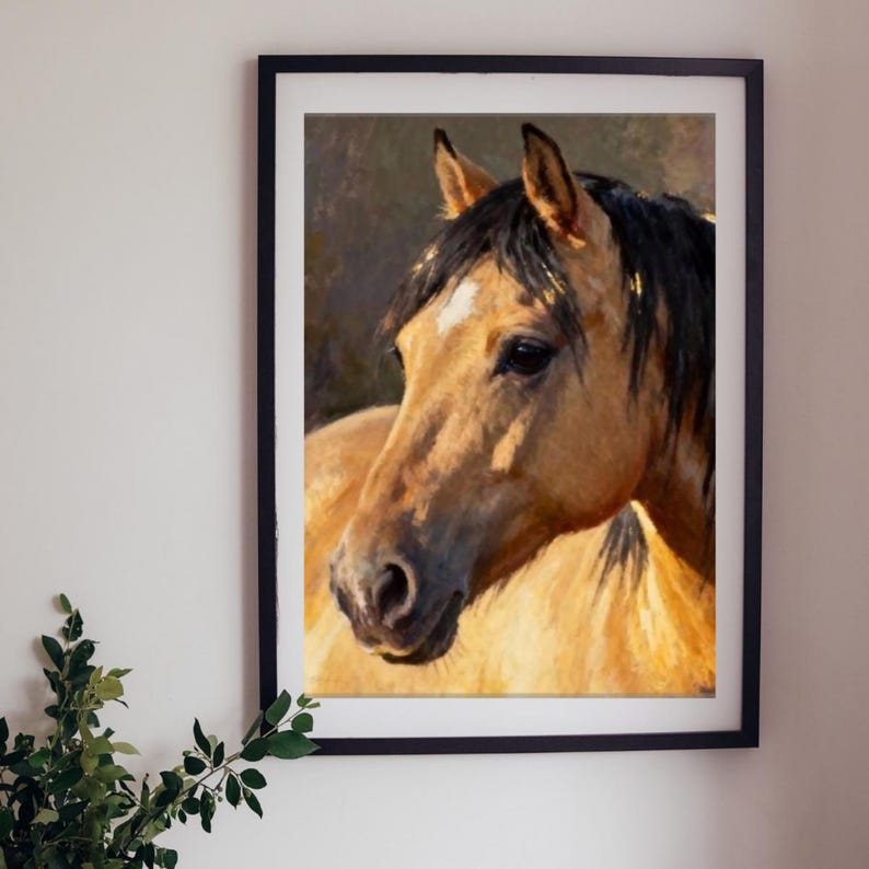 May include: A framed wall art print featuring an oil painting of a buckskin horse head and neck. The horse has a tan coat, a dark mane, and a small white star on its forehead. The artwork is enclosed in a simple black rectangular frame.