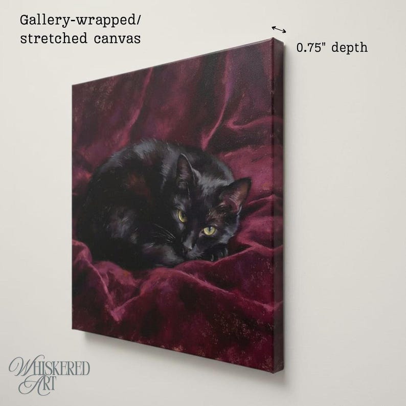 May include: A gallery-wrapped stretched canvas print featuring a black cat resting on a deep burgundy fabric background. The artwork has a 0.75 inch depth, showcasing the cat with yellow-green eyes curled up against the dark red draped material.