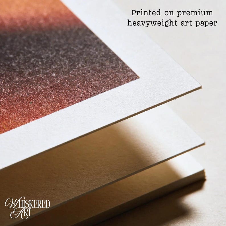 May include: A stack of three thick sheets of white art paper with a textured surface. The top sheet features a printed gradient of orange, brown, and black colors. The text "Printed on premium heavyweight art paper" is visible at the top.