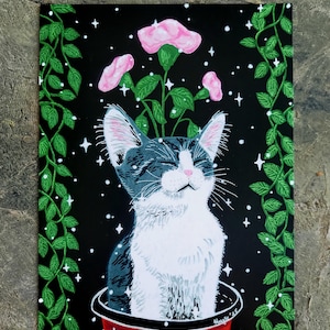 May include: A black and white cat with pink flowers growing out of its head, sitting in a red pot. The background is black with white stars and green vines.
