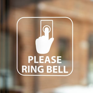 May include: White sign with a hand pointing to a button and the text "PLEASE RING BELL".