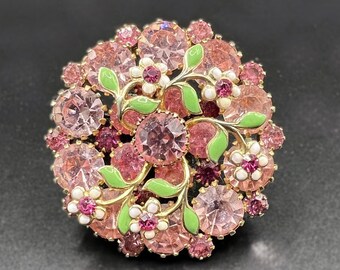 Vintage 1950's pink aurora borealis AB rhinestone brooch with stylised white, green and pink flower design.  Set in gold-tone metal.