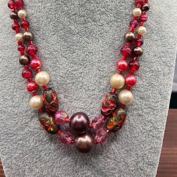 Vintage 1950s 2-strand beaded necklace/choker. Shades of red, plum, pink, fuchsia, faux pearls. Gold-tone dragon style clasp. Japan marked.