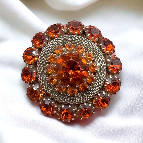 1950's WEISS signed vintage round dome brooch featuring sparkling orange rhinestones set in silver-tone textured metal