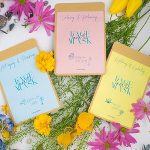 May include: Three face mask packages with different colours and designs. The packages are labelled with the text "Face Fanatic Mask" and the benefits of each mask. The text on the packages reads "Anti-aging & Plamping", "Calming & Balancing", and "Brightening & Hydrating".
