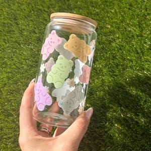 Clear glass cup featuring a fun and vibrant wrap of colorful gummy bears. Perfect for iced drinks like coffee, tea, or boba. Bright, playful design with a kawaii aesthetic.