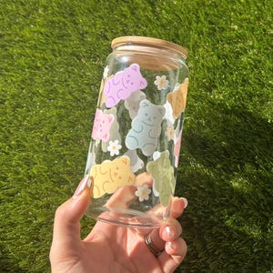 Close-up of the gummy bear pattern on a clear glass cup, showing the glossy, vibrant colors and detailed design.