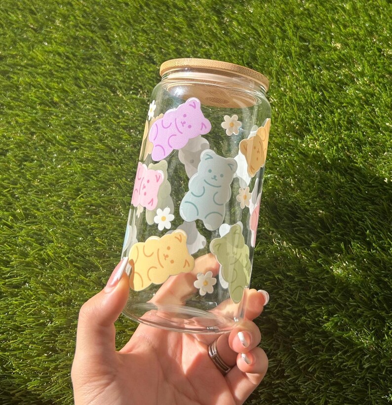 Close-up of the gummy bear pattern on a clear glass cup, showing the glossy, vibrant colors and detailed design.