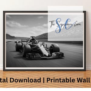 May include: Black and white framed print of a Formula 1 race car speeding on a track. The image features a grayscale color scheme with a blurred background of a cloudy sky and distant hills. The text "The Sapphire Cove" is in the upper right corner.