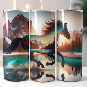 May include: Three stainless steel tumblers with a wraparound design featuring a running horse silhouette superimposed over a mountain and lake landscape. The design incorporates shades of blue, orange, and brown, with a white straw.