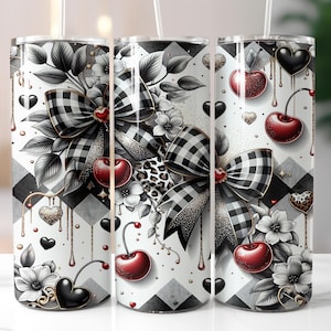 May include: A set of three stainless steel tumblers with a decorative design. The design features black and white gingham bows, cherries, hearts, and floral accents. The tumblers have a black and white checkered pattern background.