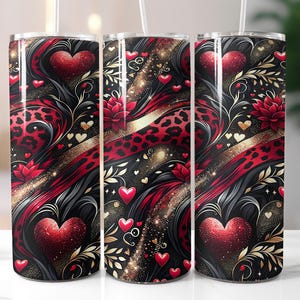 May include: Three stainless steel tumblers with a Valentine's Day theme. The design features red hearts, gold accents, and a black background with a leopard print pattern. Each tumbler has a clear straw.