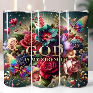 May include: A set of three stainless steel tumblers with floral and butterfly designs. The tumblers feature a dark teal background with a vibrant arrangement of flowers, butterflies, and the text "GOD IS MY STRENGTH" in gold lettering.
