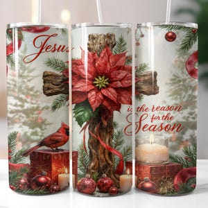 May include: A tumbler featuring a Christmas design with a wooden cross adorned with a red poinsettia. The tumbler has the text "Jesus is the reason for the Season" and includes a red cardinal, ornaments, and candles.