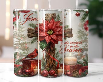 May include: A tumbler featuring a Christmas design with a wooden cross adorned with a red poinsettia. The tumbler has the text "Jesus is the reason for the Season" and includes a red cardinal, ornaments, and candles.