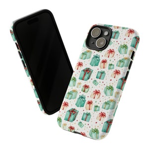 Puede incluir: Una funda de tel&eacute;fono blanca con un patr&oacute;n de regalos envueltos en verde y rojo con estrellas blancas. La funda tiene un recorte para el objetivo de la c&aacute;mara negro.