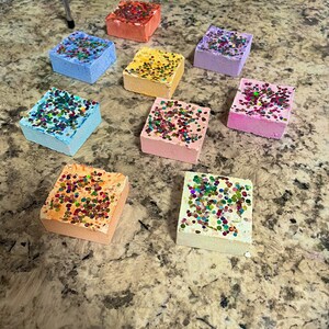 18 Soft, fluffy, crunchy medium square with multicolored holographic glitter atop gym chalk reforms ASMR anxiety relief