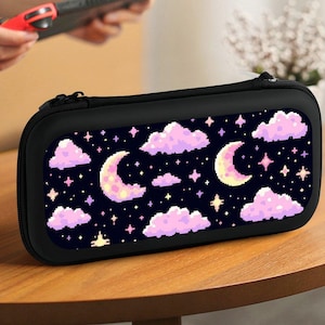 May include: Black Nintendo Switch carrying case with a pixelated design of pink clouds, yellow stars, and white crescent moons on a dark blue background.