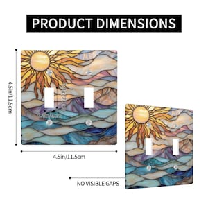 May include: Light switch cover with a stained glass design. It features a sun, mountains, and water in orange, yellow, blue, and purple. The cover measures 11.5cm by 11.5cm.