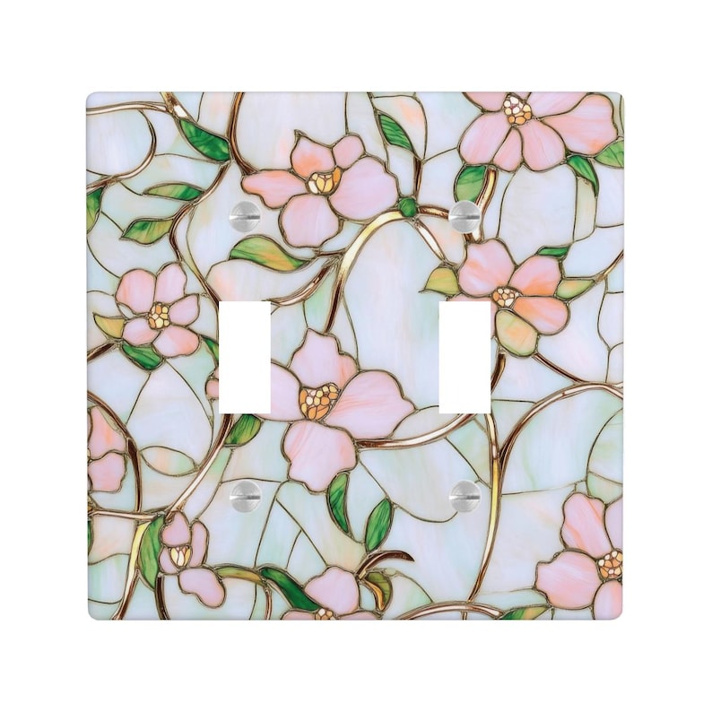 May include: A decorative light switch cover featuring a stained glass design. The cover has a square shape and is adorned with pink flowers, green leaves, and gold-colored stems against a pale blue background.
