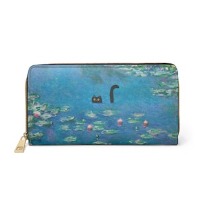 May include: A blue wallet with a gold zip and a black cat design. The cat's head and tail are visible in a pond scene, reminiscent of a Monet painting. The wallet features a landscape of lily pads and water lilies.
