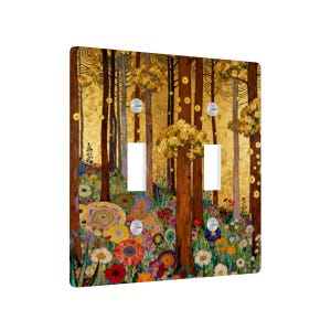 May include: A decorative double light switch cover featuring a colorful forest scene. The artwork depicts tall brown trees with golden foliage and a vibrant array of flowers in shades of red, yellow, and blue. The cover has two light switch openings and silver screws.