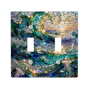 May include: A decorative light switch cover with a mosaic design of a breaking ocean wave. The artwork uses blue, green, and gold, with jellyfish and fish. The cover has two switch openings and silver screws.