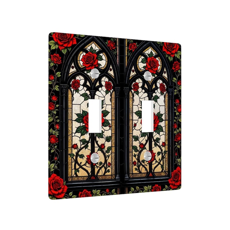 May include: A decorative double light switch cover featuring a stained-glass design. The design includes red roses, green leaves, and a black gothic arch pattern. The background is a light beige color.