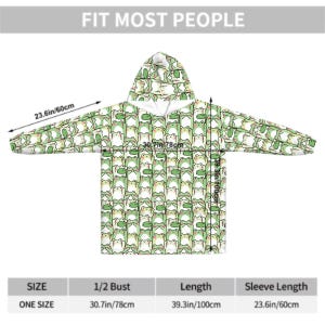 May include: One-size hooded blanket with a repeating pattern of green frogs on a white background. The blanket has a hood and long sleeves. The sleeve length is 23.6 inches (60cm), the bust is 30.7 inches (78cm), and the length is 39.3 inches (100cm).