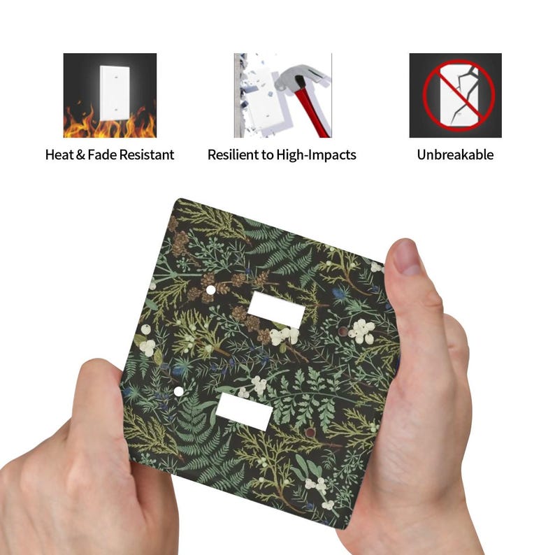 May include: A decorative light switch cover with a botanical pattern of green and white foliage on a dark background. The cover has two rectangular cutouts for the switches. The image also shows icons with the text: Heat & Fade Resistant, Resilient to High-Impacts, and Unbreakable.