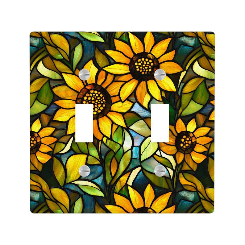 May include: A decorative double light switch cover featuring a stained-glass design of sunflowers. The cover has a square shape with two rectangular cutouts for the switches. The sunflowers are yellow with brown centers, surrounded by green leaves and a blue background.
