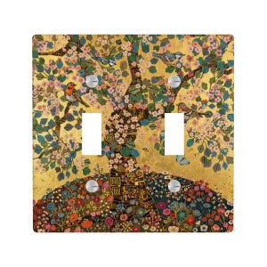 May include: A decorative double light switch cover with a tree design, birds, flowers, and butterflies. The artwork has a gold background with colourful accents, creating a vibrant and artistic look.
