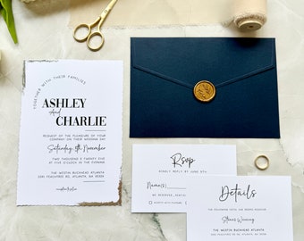 May include: Wedding invitation suite with a navy blue envelope, a white RSVP card, and a white invitation card with gold foil accents. The invitation card features the text "Together with their families, Ashley and Charlie, request the pleasure of your company on their wedding day, Saturday, 5th November, Two thousand twenty-five at five o'clock in the evening, The Westin Buckhead Atlanta, 3391 Peachtree Rd. Atlanta, GA 30326."