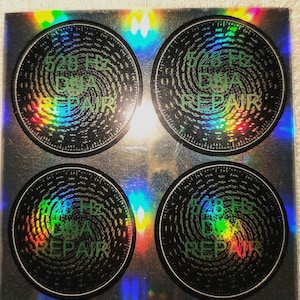 May include: Four black and green holographic stickers with a swirling pattern and the text "528 Hz DNA REPAIR" on each.
