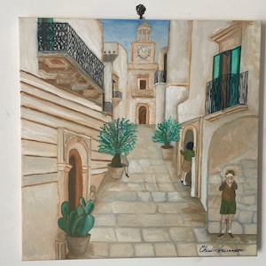 May include: Square painting depicting a European town square with a clock tower. The artwork features a stone staircase, potted plants, and figures. The color palette includes beige, white, and blue tones. The artist's signature is visible in the lower right corner.