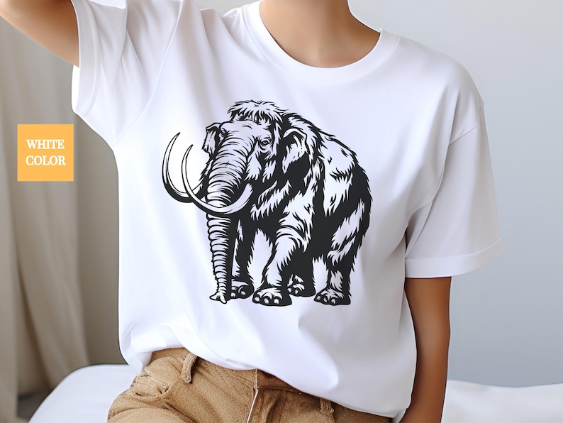 May include: A white t-shirt with a black and white illustration of a woolly mammoth.