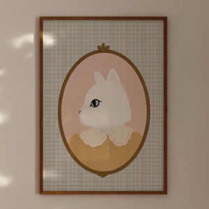 May include: A framed print of a white cat wearing a yellow dress with a white collar. The cat is looking to the side and the background is a light blue and white checkered pattern.